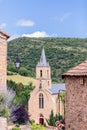 Church of St. Christopher, part of medieval building with masonry and roof tiles on entrance of Peyre village,ÃÂ Aveyron, Occitania